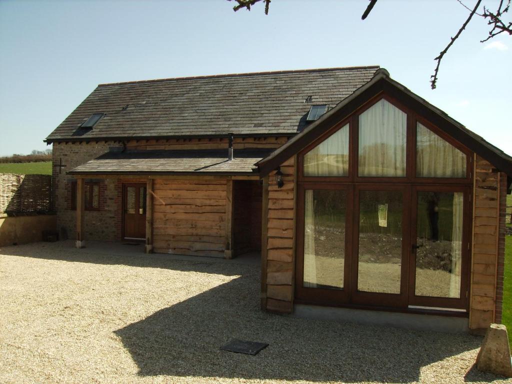 a barn with a large glass door on it at Crowthorne, Bookham Court in Dorchester