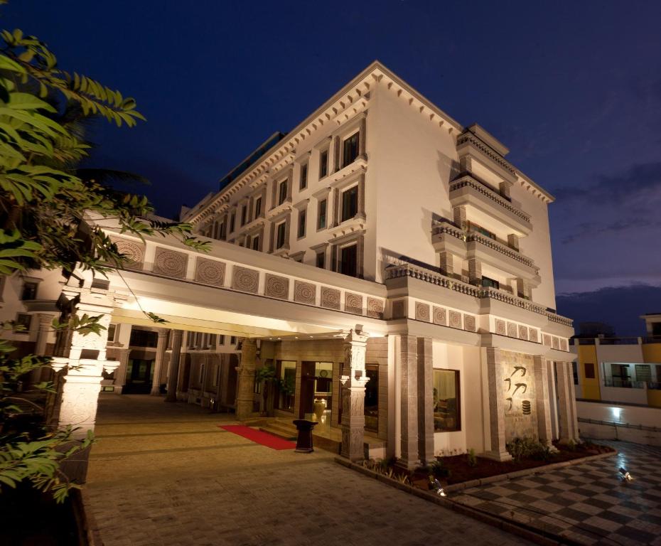 a large white building at night at JC Residency Madurai in Madurai