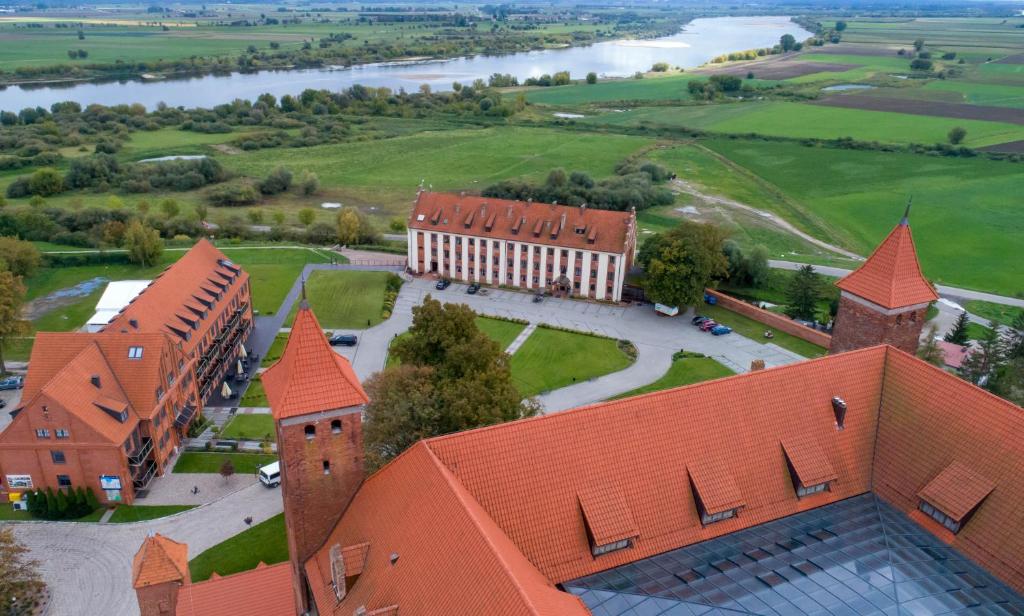 an aerial view of a large building with red roofs at Zamek Gniew - Pałac Marysieńki in Gniew
