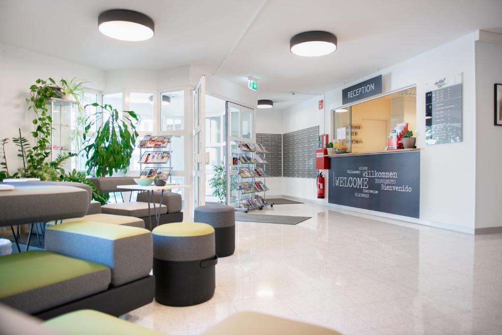 a store with tables and stools in a room at myNext - Riverside Hotel Salzburg in Salzburg