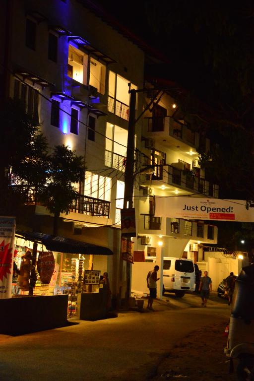 a building lit up at night with blue lights at Gloria Grand Hotel in Unawatuna