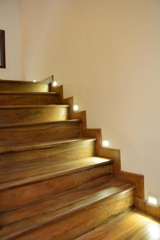 a staircase with wooden floors and lights on it at Gloria Grand Hotel in Unawatuna