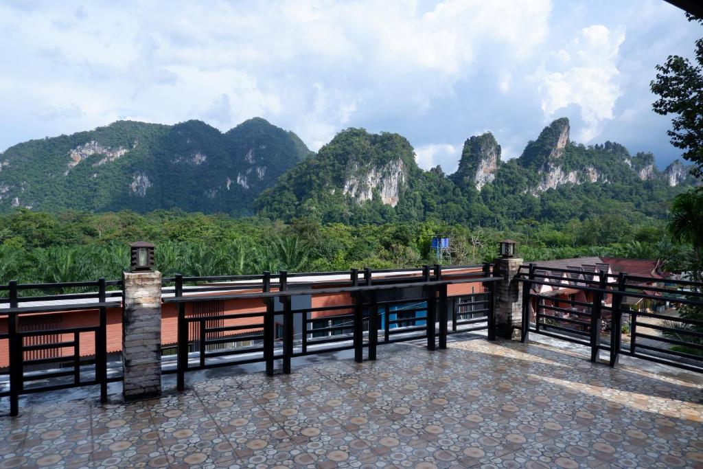 a balcony with a view of a mountain range at Khao Sok Nature Place - SHA Certified in Khao Sok