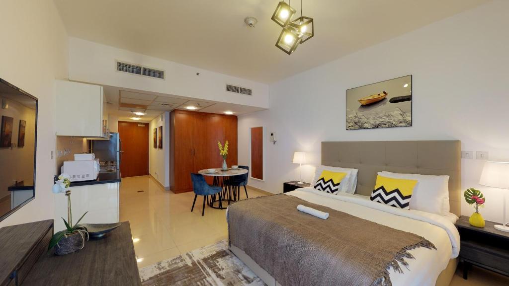 a bedroom with a large bed and a living room at LuxBnB - Park Towers - DIFC in Dubai