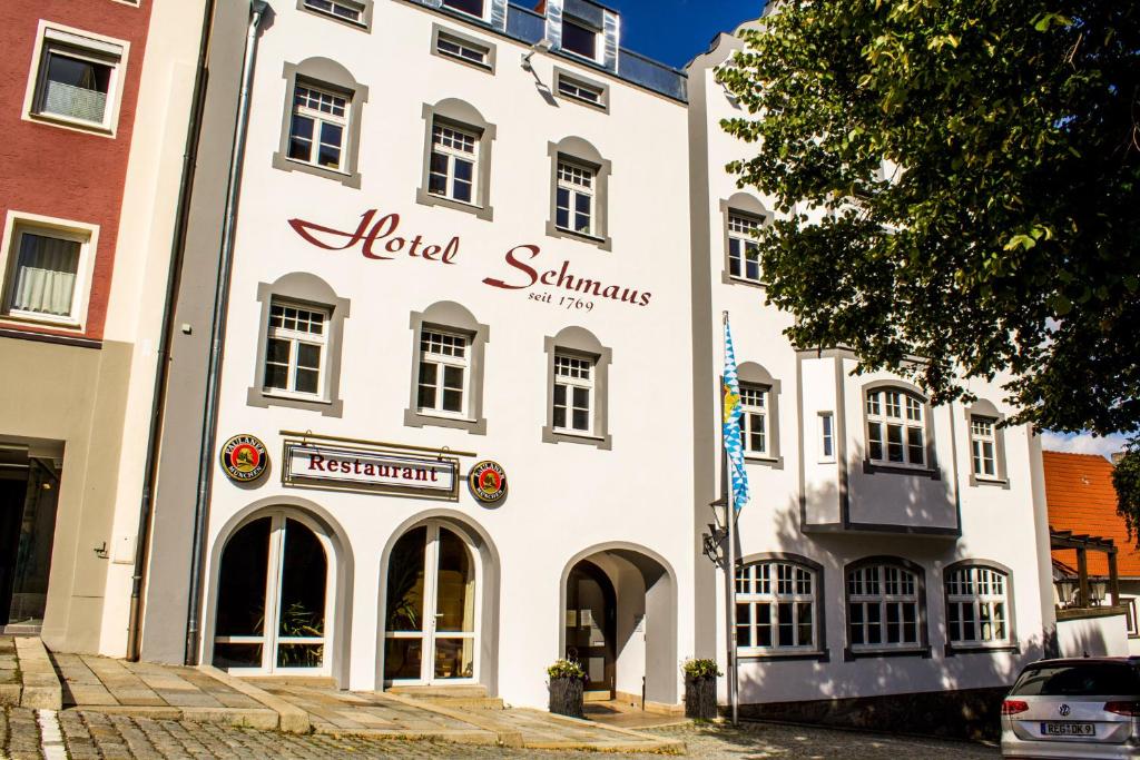 a white building with a hotel sign on it at Garni Hotel Schmaus in Viechtach