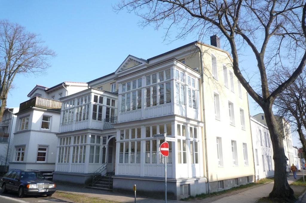 a large white building with a stop sign in front of it at Haus Louise/Sternenblick in Warnemünde