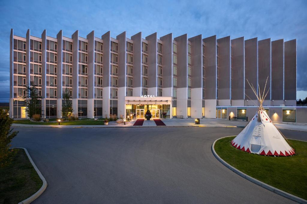 a hotel building with a large building at Grey Eagle Resort in Calgary