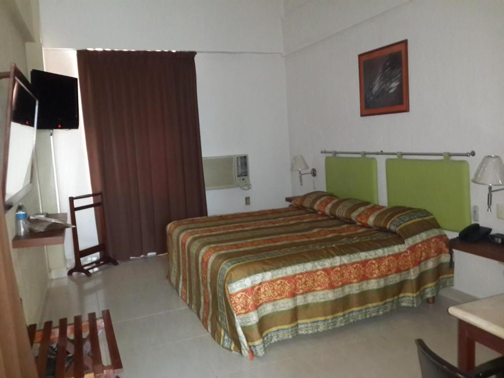 Postel nebo postele na pokoji v ubytování Parque Inn Hotel & Suites