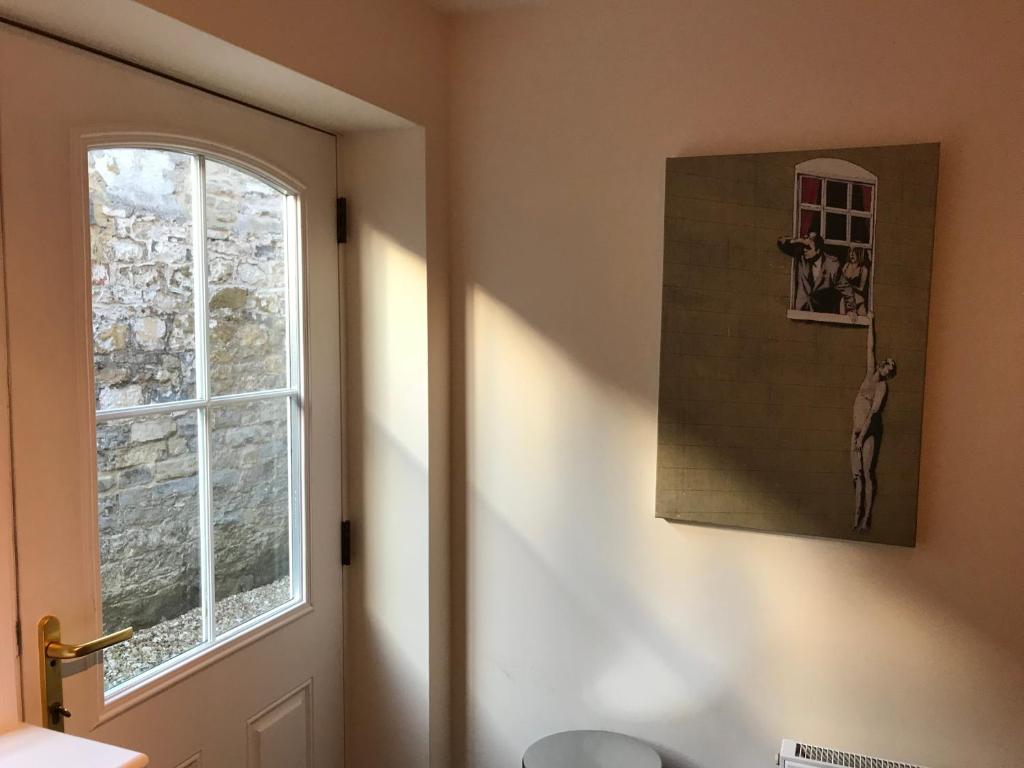 baño con ventana, aseo y puerta en 2 Crown Barton, en Glastonbury