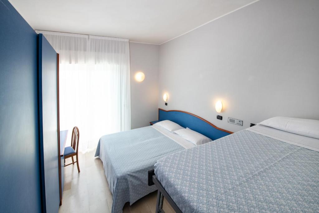Łóżko lub łóżka w pokoju w obiekcie Hotel Torretta