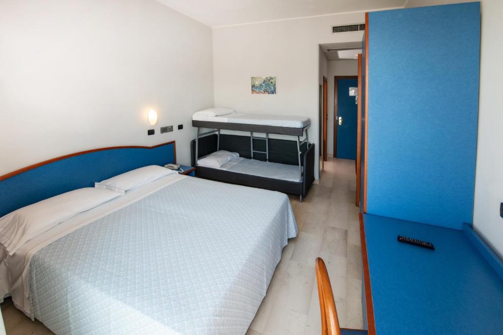 Łóżko lub łóżka w pokoju w obiekcie Hotel Torretta