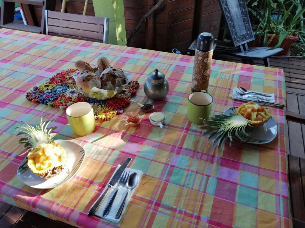 a table with a table cloth with food on it at Cazadodo in Étang-Salé