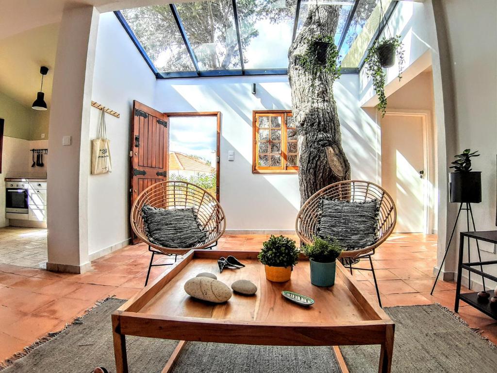 a living room with a wooden table and chairs at Beach Tree House in Porto Santo