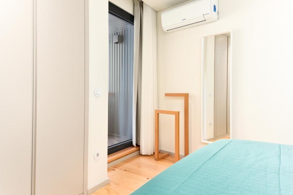 Postel nebo postele na pokoji v ubytování Bom Jardim Apartments