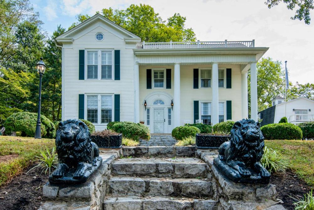 a house with two lion statues in front of it at Tolley House in Lynchburg