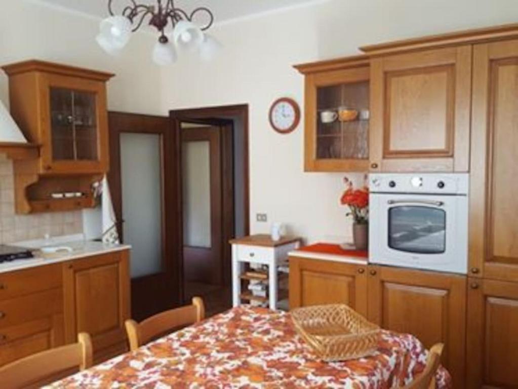 a kitchen with a table and a white oven at CASA ALESSANDRA in Chiuro