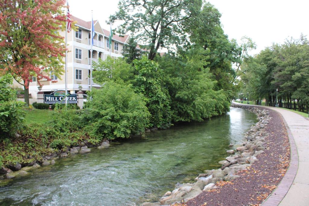 a river next to a street and a building at Mill Creek Hotel in Lake Geneva