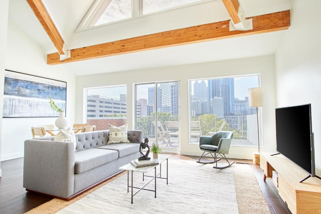 a living room with a couch and a tv at Sonder Baltimore Place in Atlanta