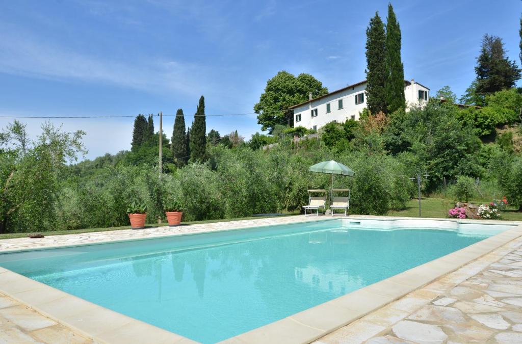 a swimming pool with a house in the background at Villa Buonaparte in San Miniato