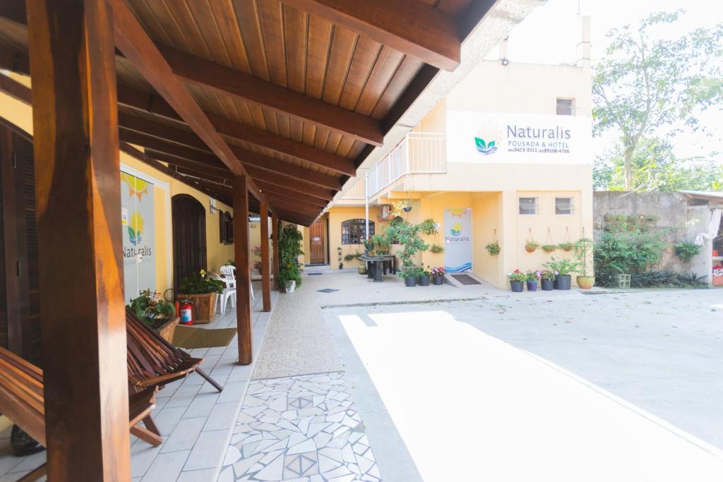 an outside view of a building with a patio at Hotel Naturalis in Paranaguá
