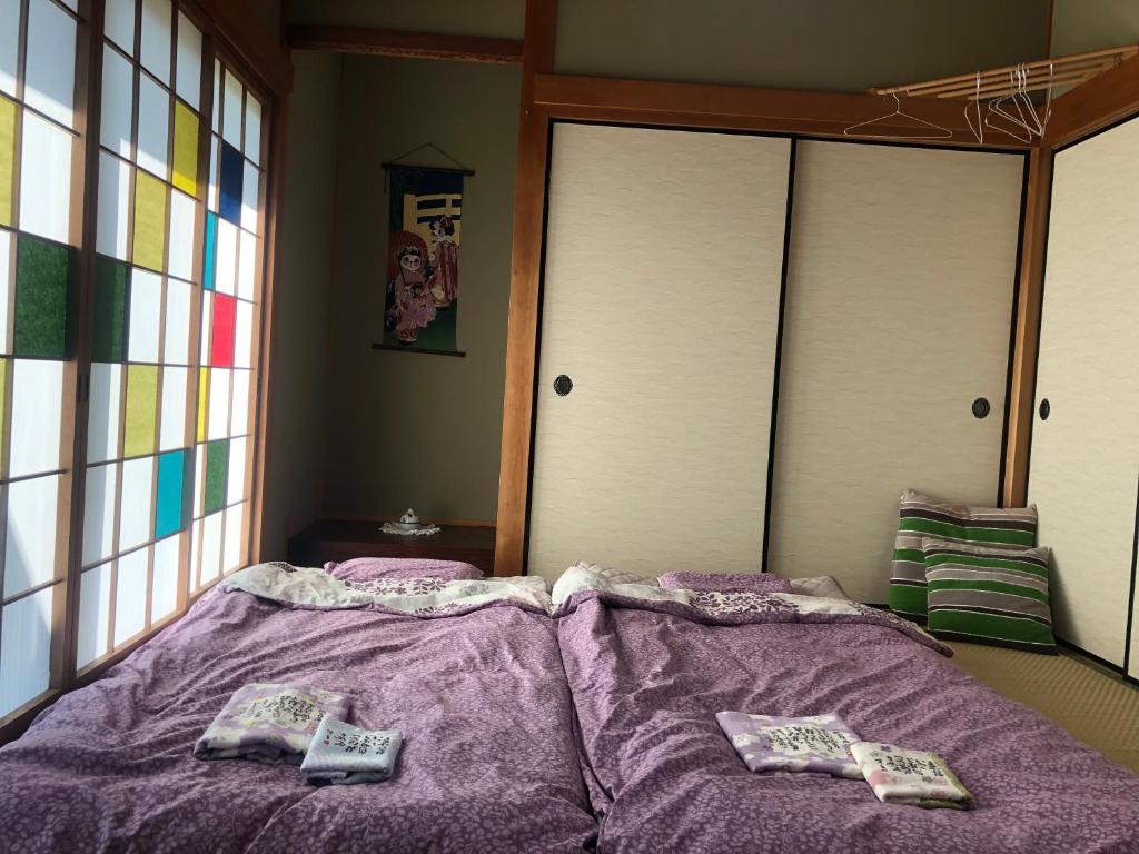 Postel nebo postele na pokoji v ubytování Guesthouse Yui