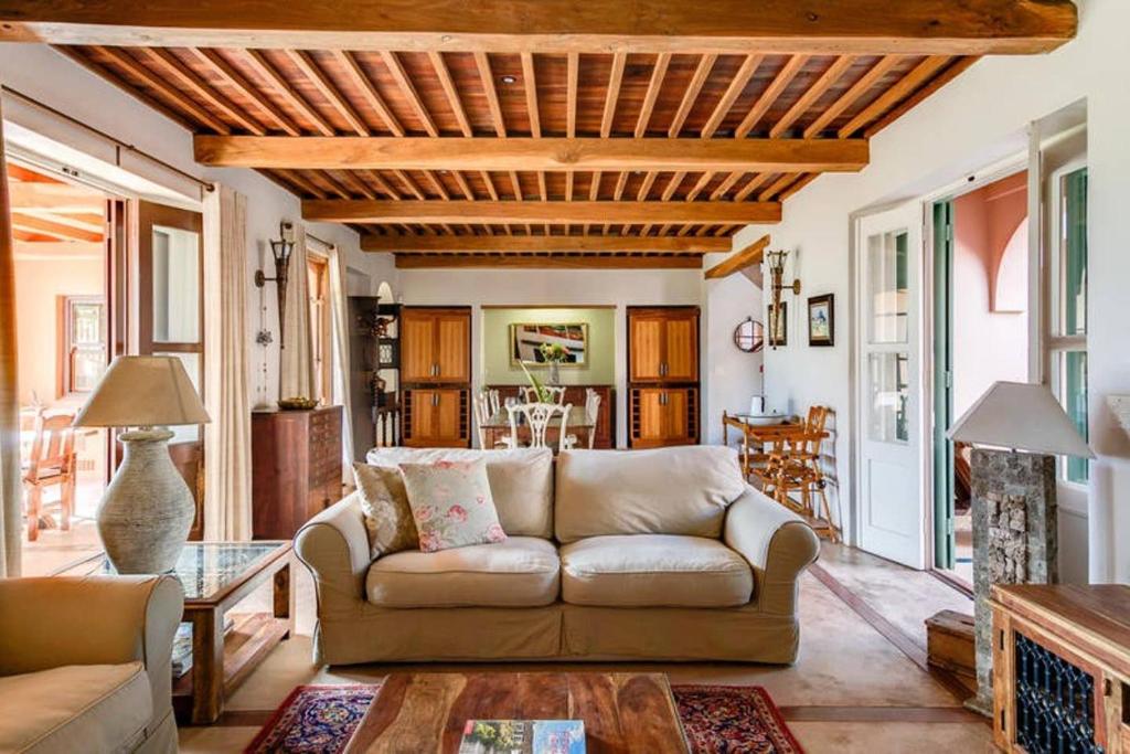 a living room with a couch and a table at Nooitgedacht Country House in Boesmanspad