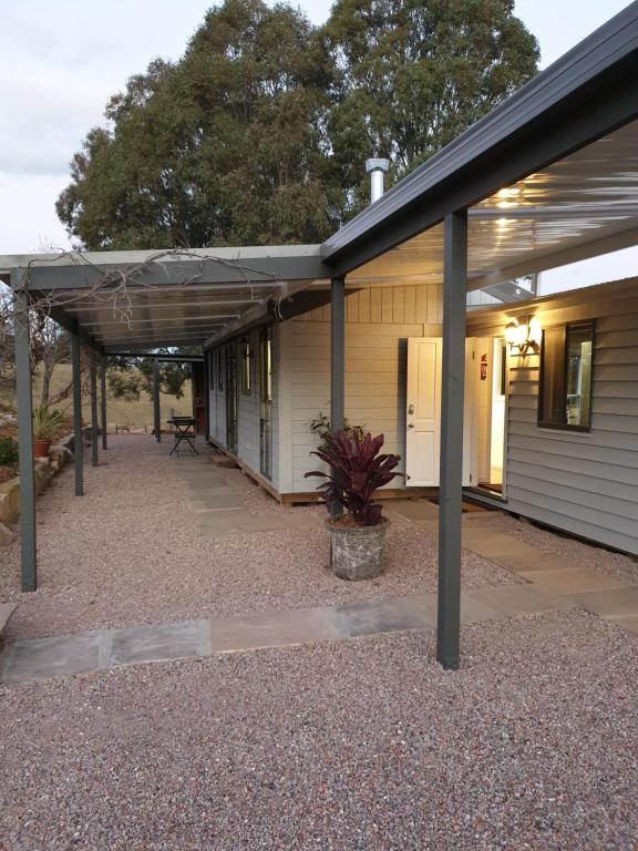 a building with a porch and a patio at Charolais Cottage in Picton