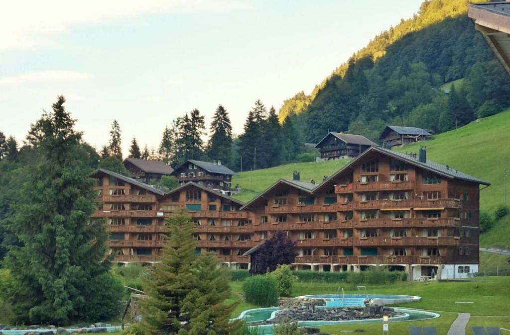 a large hotel with a mountain in the background at The River Pearl in Val dʼIlliez