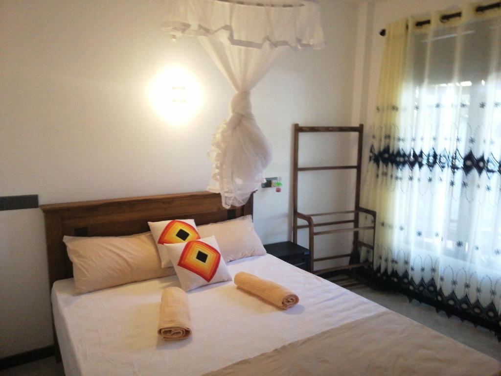 Postel nebo postele na pokoji v ubytování Flip Flop Inn Mirissa