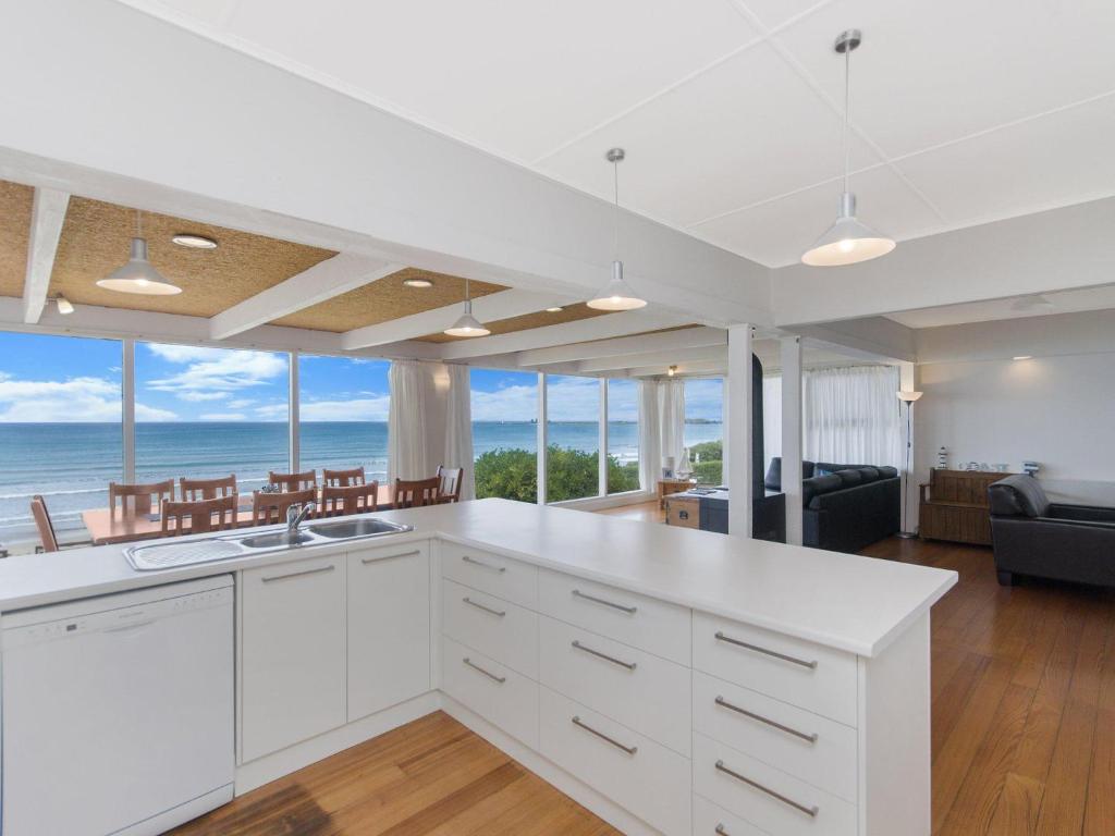 a kitchen with white cabinets and a view of the ocean at ONE FISH, TWO FISH in Port Fairy