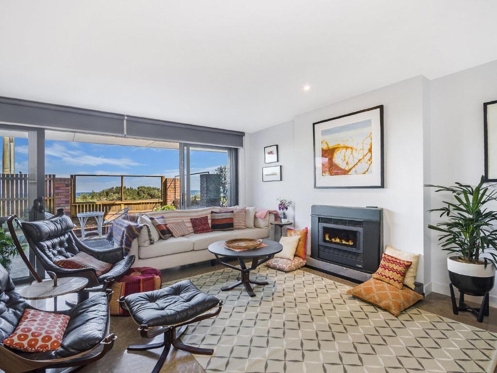 a living room with a couch and a fireplace at Pea Soup Beach in Port Fairy