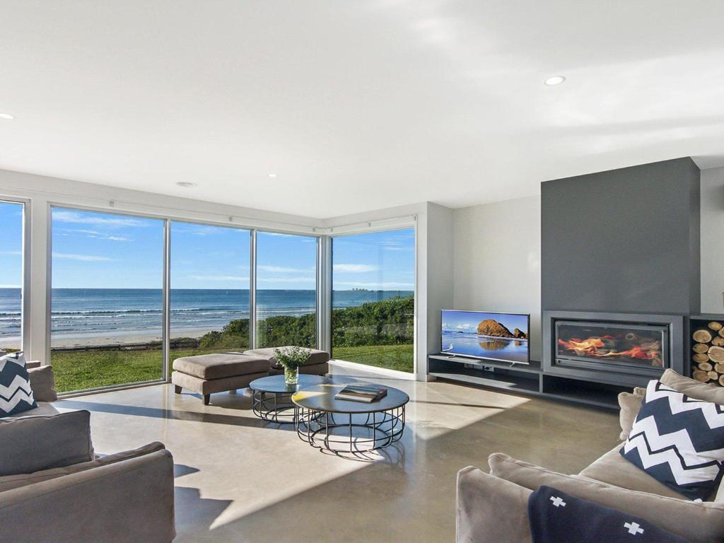a living room with a view of the ocean at Saltwater Lodge in Port Fairy