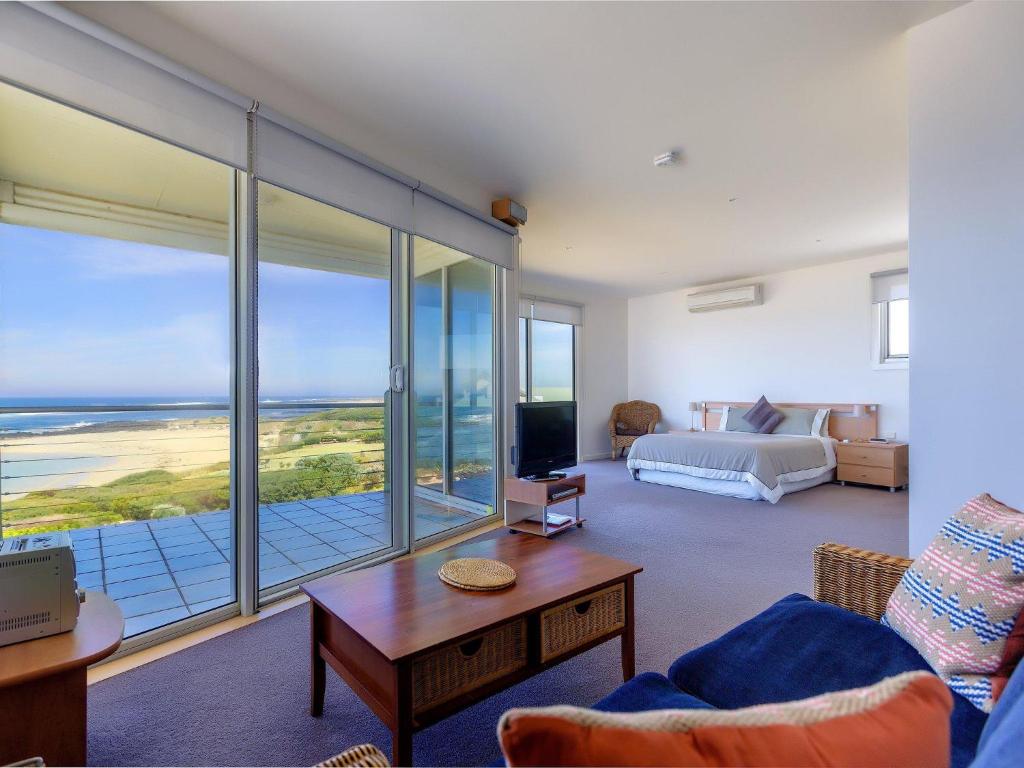 a living room with a bed and a view of the ocean at Wytonia 3 Penthouse in Port Fairy