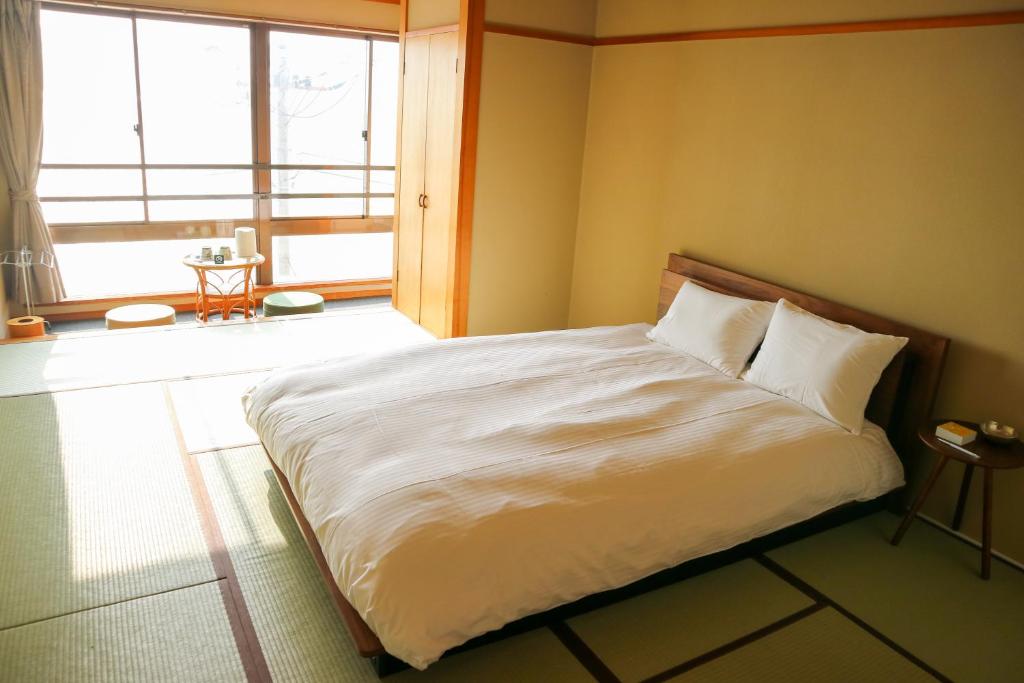 Postel nebo postele na pokoji v ubytování HOTEL&RESORT Izu no Ne