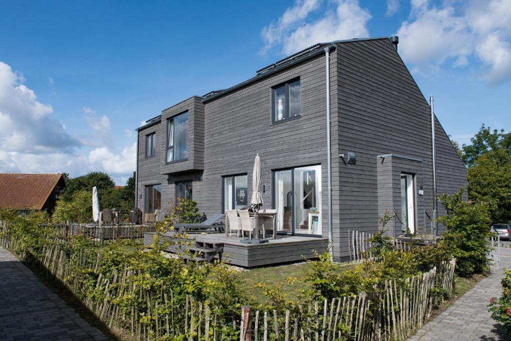 a gray house with a fence in front of it at Schiff in Gelting