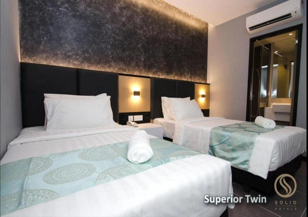 Postel nebo postele na pokoji v ubytování Solid Hotels