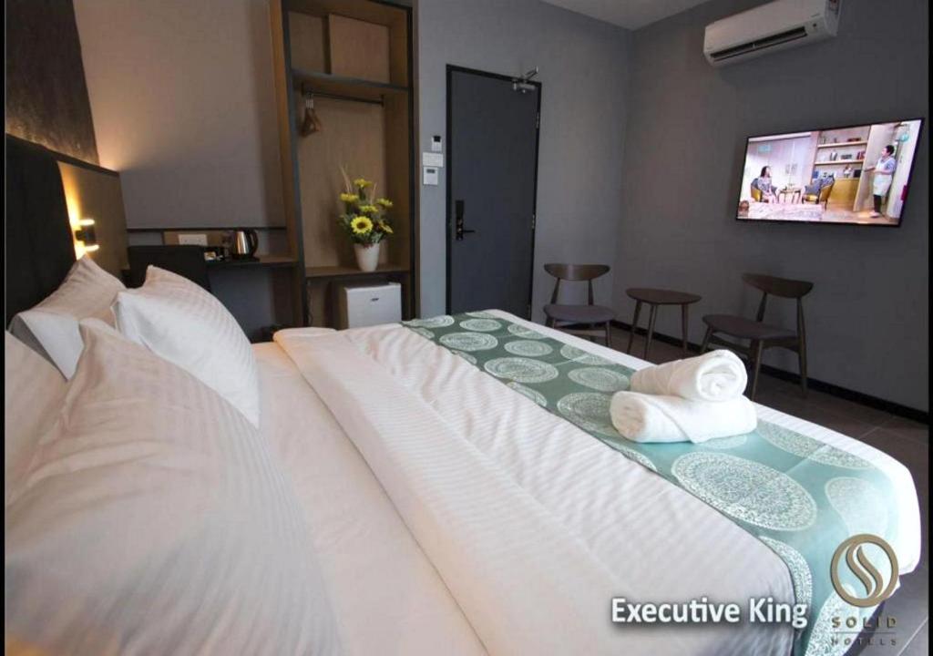 Postel nebo postele na pokoji v ubytování Solid Hotels