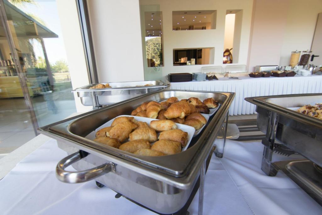 a buffet line with a bunch of pastries at Riviera Perdika Hotel in Perdika