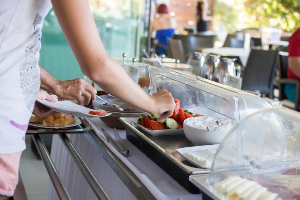 a group of people preparing food at a buffet at Riviera Perdika Hotel in Perdika