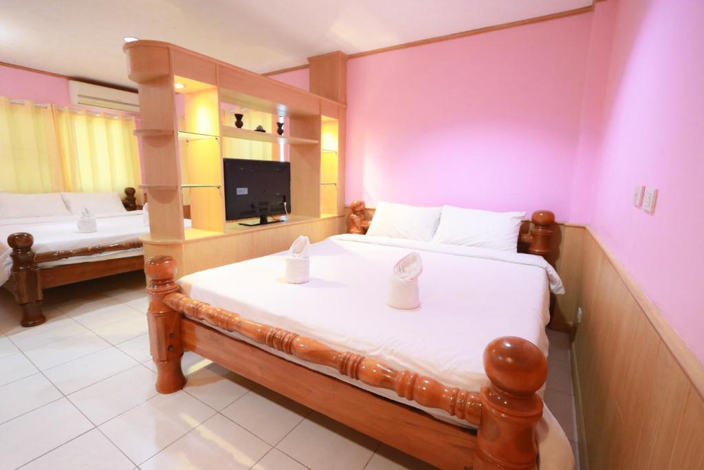 Postel nebo postele na pokoji v ubytování Chiang Rai Park Resort