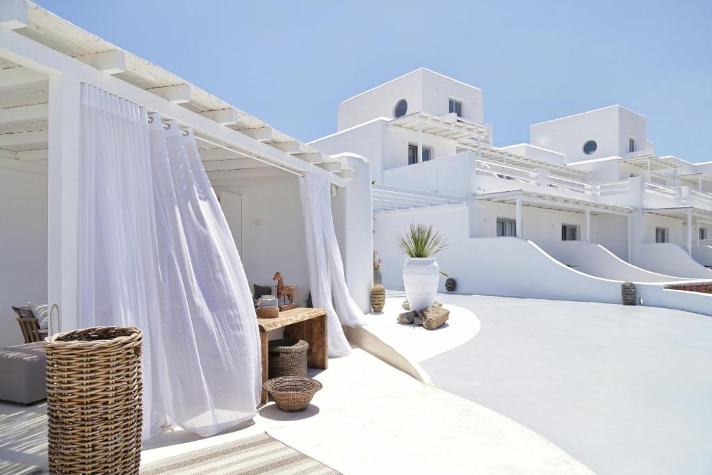 a white villa with white fences and white buildings at Livin Mykonos Hotel in Mikonos