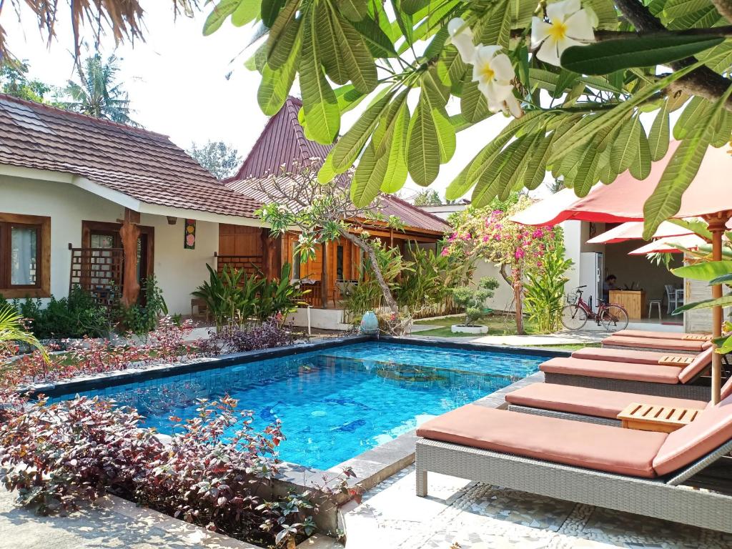 a swimming pool in the backyard of a house at Villa Kinagu in Gili Meno