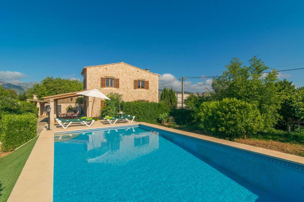 a large swimming pool in front of a house at Can Tut in Campanet