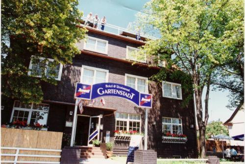 a building with a sign in front of it at Hotel and Restaurant Gartenstadt in Erfurt