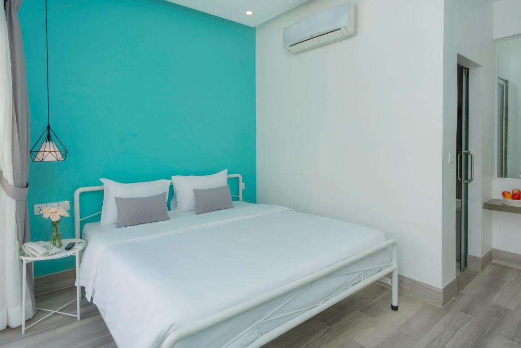 Postel nebo postele na pokoji v ubytování Glow Inn Siem Reap