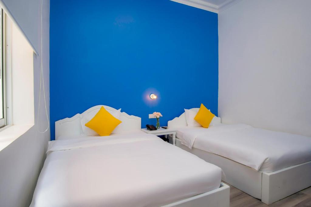 Postel nebo postele na pokoji v ubytování Glow Inn Siem Reap