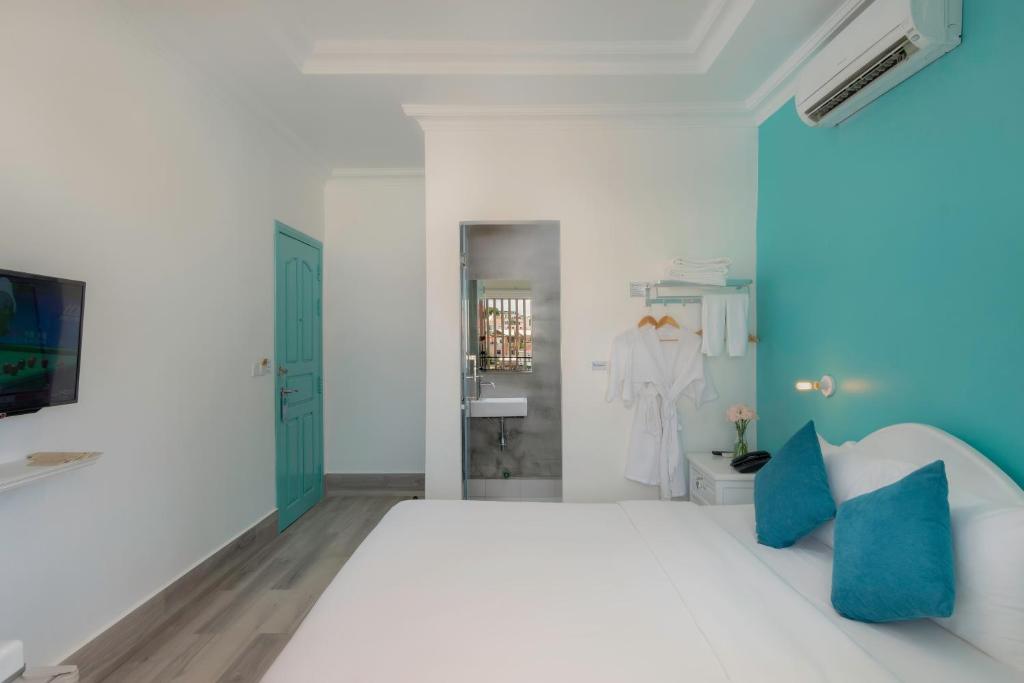 Postel nebo postele na pokoji v ubytování Glow Inn Siem Reap