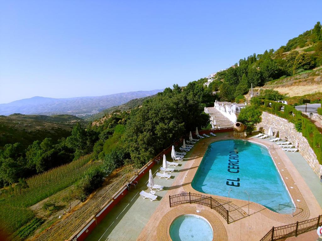an aerial view of a swimming pool with lounge chairs at Turismo Rural & SPA El Cercado in Bérchules