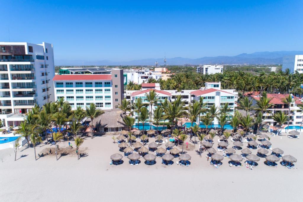 an aerial view of a resort with chairs and umbrellas on the beach at Hotel Villa Varadero in Nuevo Vallarta 