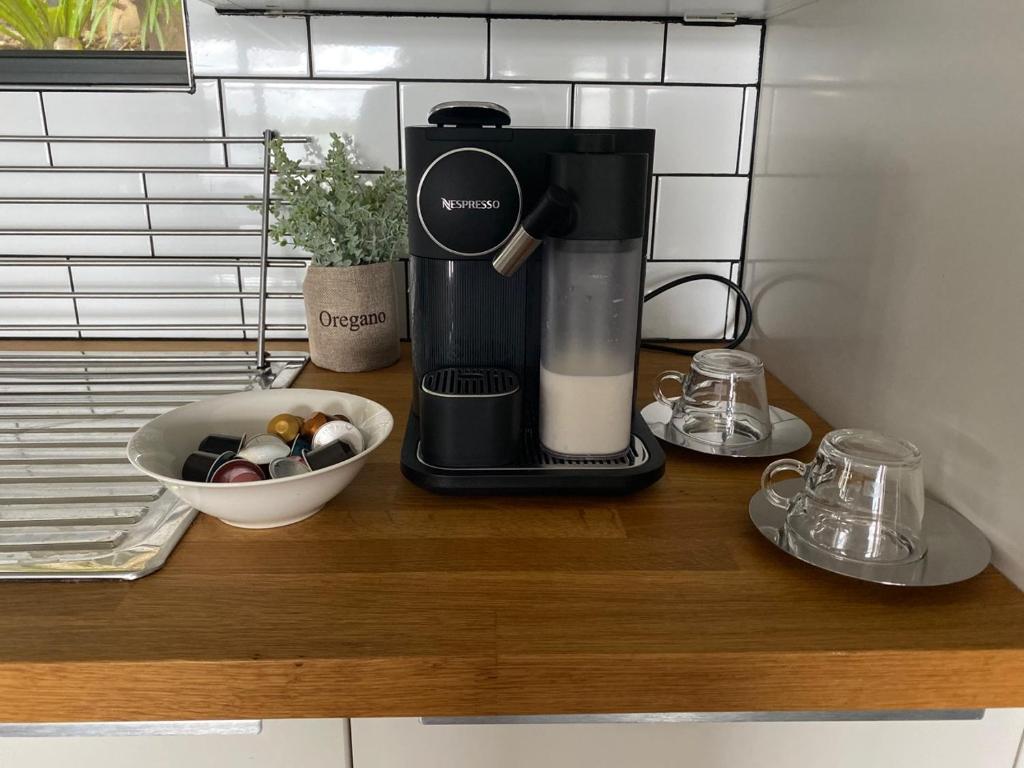 a coffee maker sitting on a counter next to a bowl of coffee at Serenity by the Lake - Romantic Waterfront Couple's Getaway in Marks Point